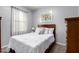 Neutral bedroom featuring a wood headboard and plush pillows at 213 S 225Th Ln, Buckeye, AZ 85326