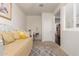 Bright bedroom featuring cozy daybed, a writing desk, neutral decor and plush carpeting at 213 S 225Th Ln, Buckeye, AZ 85326