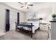 Cozy bedroom featuring a decorative metal bed frame, light walls, and neutral carpet at 213 S 225Th Ln, Buckeye, AZ 85326