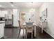 Open dining area with modern chandelier and sliding glass door leading to backyard at 213 S 225Th Ln, Buckeye, AZ 85326