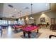 Spacious game room with multiple pool tables and ample seating areas at 213 S 225Th Ln, Buckeye, AZ 85326