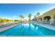 Resort-style pool with sparkling water, lounge chairs, and palm trees for ultimate relaxation at 213 S 225Th Ln, Buckeye, AZ 85326