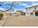 Wide open backyard with play structure, mature tree, and a view of neighbors at 23693 W La Vista Cir, Buckeye, AZ 85396