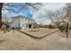 Exterior view of house with flat, large backyard, play structure, and patio at 23693 W La Vista Cir, Buckeye, AZ 85396