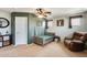 Cozy bedroom with ceiling fan, neutral carpet and accent green wall featuring woodland decals at 23693 W La Vista Cir, Buckeye, AZ 85396