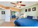 Bedroom featuring a ceiling fan, window with blinds, and mirrored sliding door closet at 23693 W La Vista Cir, Buckeye, AZ 85396