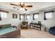 Bedroom featuring several windows, a recliner, bed and bookcase at 23693 W La Vista Cir, Buckeye, AZ 85396