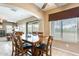 Comfortable dining area adjacent to a backyard patio, with a ceiling fan and natural light from the windows at 23693 W La Vista Cir, Buckeye, AZ 85396