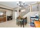 Cozy dining area with a wooden table, four chairs, and a view of the staircase at 23693 W La Vista Cir, Buckeye, AZ 85396