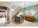 Dining area with staircase access, piano, and chandelier at 23693 W La Vista Cir, Buckeye, AZ 85396