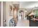 Hallway featuring tiled flooring, a staircase, and access to various living spaces at 23693 W La Vista Cir, Buckeye, AZ 85396