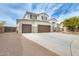 Gorgeous two-story house with a three-car garage, lovely desert landscaping, and a spacious driveway at 23693 W La Vista Cir, Buckeye, AZ 85396