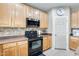 Functional kitchen with black appliances, wooden cabinets, tiled backsplash, and a door to a pantry at 23693 W La Vista Cir, Buckeye, AZ 85396