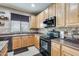 Well-equipped kitchen showcasing stainless steel appliances, wooden cabinets, and practical design elements at 23693 W La Vista Cir, Buckeye, AZ 85396