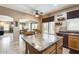 Spacious kitchen with central island, providing seating and an open view to the living and dining spaces at 23693 W La Vista Cir, Buckeye, AZ 85396