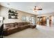 Open living room adjacent to the dining area, featuring a sectional sofa and sliding doors to the outdoor space at 23693 W La Vista Cir, Buckeye, AZ 85396