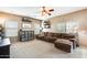 Spacious living room featuring plush furniture, lots of decor, and natural light from the large window at 23693 W La Vista Cir, Buckeye, AZ 85396