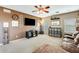 Cozy living room showcases a large entertainment center, comfortable seating, and natural light from the windows at 23693 W La Vista Cir, Buckeye, AZ 85396