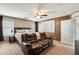 Bright main bedroom with a ceiling fan, side tables, and a comfortable couch for relaxing at 23693 W La Vista Cir, Buckeye, AZ 85396