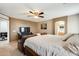 Comfortable main bedroom featuring contemporary colors, a sleek entertainment center, and an en suite bathroom at 23693 W La Vista Cir, Buckeye, AZ 85396