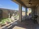 Outdoor back patio, perfect for entertaining with ceiling fan, table, chairs, and decor accents at 24986 N 172Nd Ln, Surprise, AZ 85387