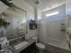 Modern bathroom with a vanity, a large mirror, shower-tub combo, and neutral-toned decor at 24986 N 172Nd Ln, Surprise, AZ 85387