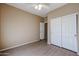 This bedroom features a ceiling fan and a closet with sliding doors at 2600 E Springfield Pl # 59, Chandler, AZ 85286