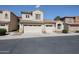 Beige, two story home with two garages, tile roof and desert landscaping at 2600 E Springfield Pl # 59, Chandler, AZ 85286