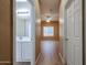 Hallway view into a half-bath and a bedroom with ceiling fan and window at 2600 E Springfield Pl # 59, Chandler, AZ 85286