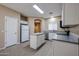 Modern kitchen with white cabinets, island, and stainless steel appliances at 2600 E Springfield Pl # 59, Chandler, AZ 85286