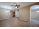 Spacious living room with wood floors, ceiling fan, and modern chandelier at 2600 E Springfield Pl # 59, Chandler, AZ 85286