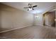 Spacious living room with wood floors, ceiling fan, and modern chandelier at 2600 E Springfield Pl # 59, Chandler, AZ 85286