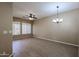 Spacious living room with wood floors, ceiling fan, and modern chandelier at 2600 E Springfield Pl # 59, Chandler, AZ 85286