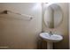 Powder room with pedestal sink, oval mirror, towel bar and textured walls at 2600 E Springfield Pl # 59, Chandler, AZ 85286