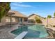 Backyard pool with diving board and rock waterfall feature, perfect for summer fun at 3060 W Ironwood Cir, Chandler, AZ 85226