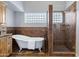 Elegant bathroom featuring a clawfoot tub, walk-in shower, and stylish tile work at 3060 W Ironwood Cir, Chandler, AZ 85226