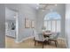 Charming dining room with view to the living room, featuring neutral chairs and arched window with shutters at 3060 W Ironwood Cir, Chandler, AZ 85226