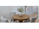 Close up of a wooden dining table with four light-colored chairs around it and a decorative vase centerpiece at 3060 W Ironwood Cir, Chandler, AZ 85226