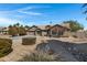 Attractive single-story home features a three-car garage, neutral stucco, and low-maintenance desert landscaping at 3060 W Ironwood Cir, Chandler, AZ 85226