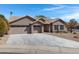 Handsome single-story home features a three-car garage, neutral stucco, and drought-tolerant landscaping at 3060 W Ironwood Cir, Chandler, AZ 85226