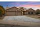 Charming home exterior showcasing a well-maintained yard and a three-car garage at 3060 W Ironwood Cir, Chandler, AZ 85226