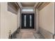 Modern front entrance featuring a black double door and desert landscaping leading to the home at 3060 W Ironwood Cir, Chandler, AZ 85226