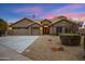 Charming single-story home with a three-car garage and desert landscaping under a vivid sky at 3060 W Ironwood Cir, Chandler, AZ 85226