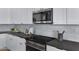 Close-up of kitchen featuring modern appliances, white cabinets, sleek countertops, and modern fixtures at 3060 W Ironwood Cir, Chandler, AZ 85226