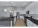 Modern kitchen with white cabinets, black countertops, stainless steel appliances, and hardwood floors at 3060 W Ironwood Cir, Chandler, AZ 85226