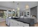 Bright, modern kitchen with stainless steel appliances, sleek countertops, and open floor plan to the living room at 3060 W Ironwood Cir, Chandler, AZ 85226