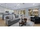 Open concept living room featuring modern decor, a gray sofa, and access to the kitchen at 3060 W Ironwood Cir, Chandler, AZ 85226