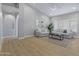 Spacious living room with vaulted ceiling, plantation shutters, light-colored sofas, and wood-look flooring at 3060 W Ironwood Cir, Chandler, AZ 85226