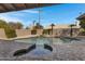 Inviting backyard pool area with a spa, rock waterfall, and stylish brick pavers at 3060 W Ironwood Cir, Chandler, AZ 85226