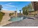 Relaxing backyard pool area with a spa, rock waterfall, and ample space for outdoor enjoyment at 3060 W Ironwood Cir, Chandler, AZ 85226